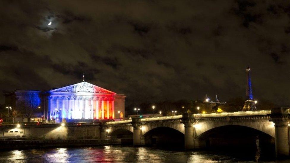 The French National Assembly lit in the colours of the French flag