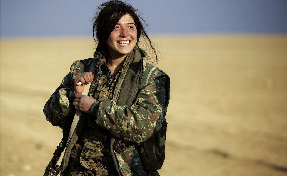 Rojin, a 19-year-old female Arab fighter among the Syrian Democratic Forces (SDF), made up of US-backed Kurdish and Arab fighters, stands in fatigues carrying a machine gun near the village of al-Torshan, 20 km on the outskirts of Raqqa on February 6, 2017