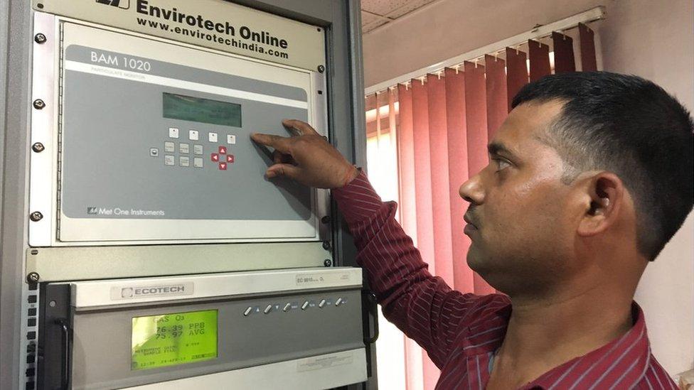 Operator Rajesh Gupta shows the machine that measure PM2.5 in Kanpur