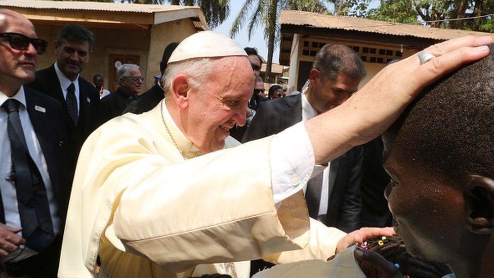 Pope Francis greets children during his visit to refugee camp of Saint Sauveur in Bangui, Central African Republic