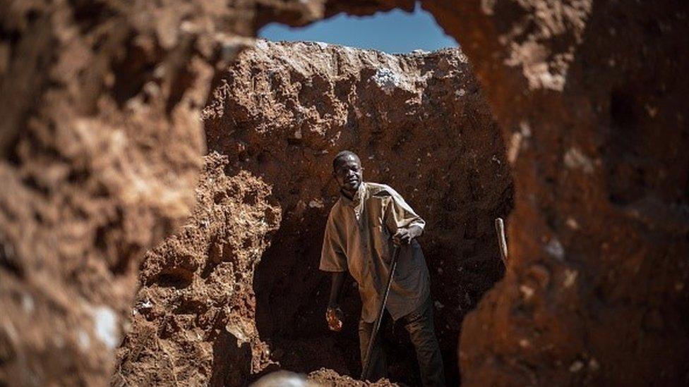 A man searches for cobalt in an old mine