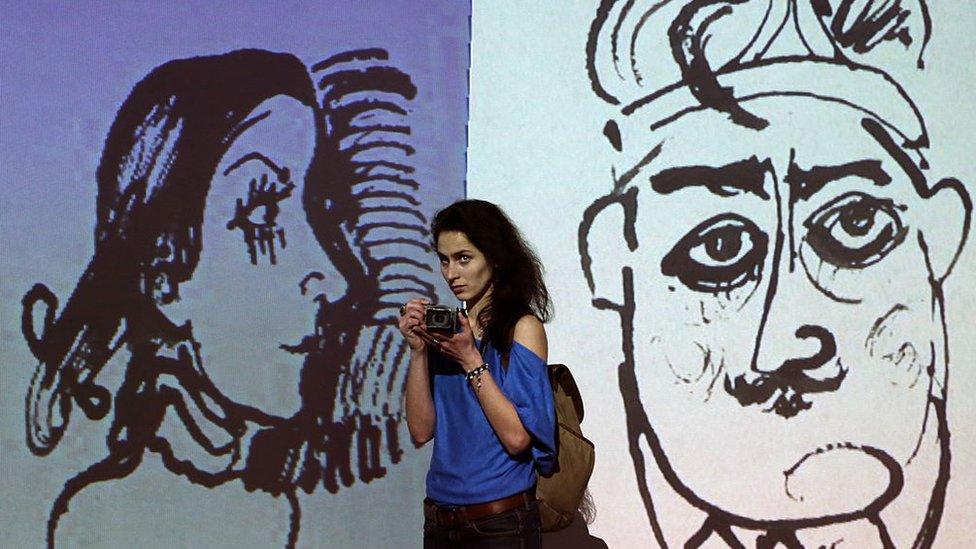 MOSCOW, RUSSIA. FEBRUARY 11, 2016. A girl attends a multimedia exhibition of works by Georgian theatre and film director, playwright, writer, painter and sculptor Revaz "Rezo" Gabriadze at the Museum of Moscow. The exhibition marks Gabriadze's 80th birthday