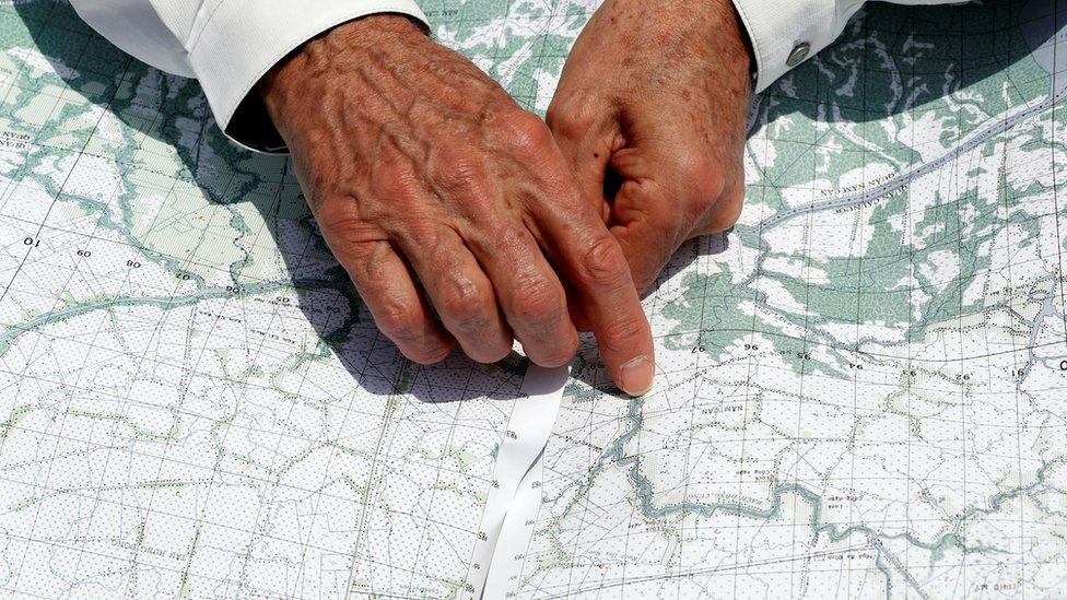 US Secretary of State John Kerry uses a map to pinpoint where the ambush took place in Vietnam