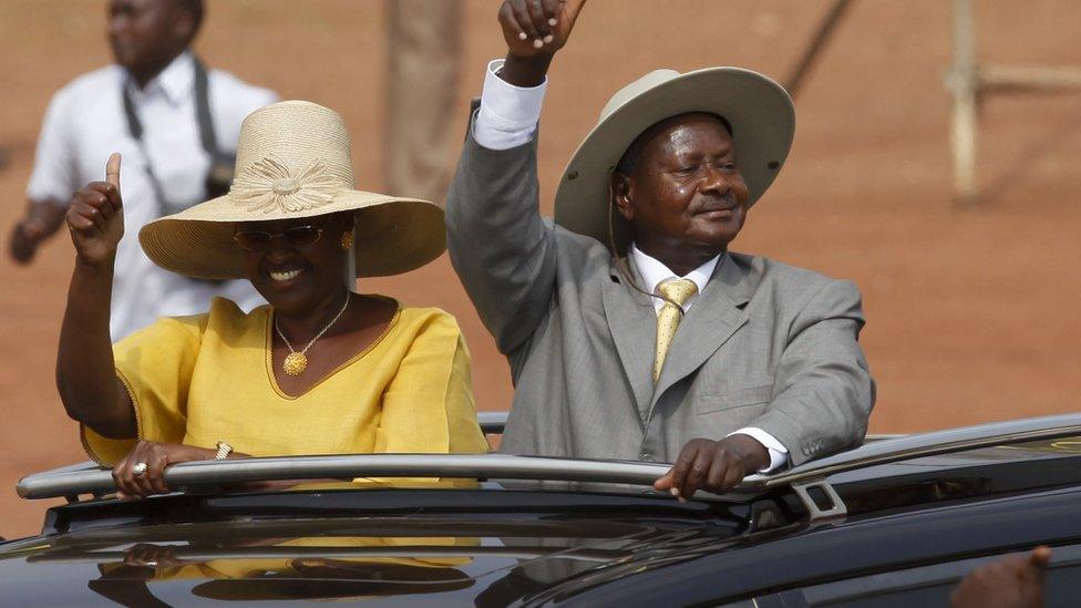 The leader of Uganda"s ruling NRM President Yoweri Museveni (R) and his wife (L) greets his supporters upon arrival at a rally in the capital Kampala