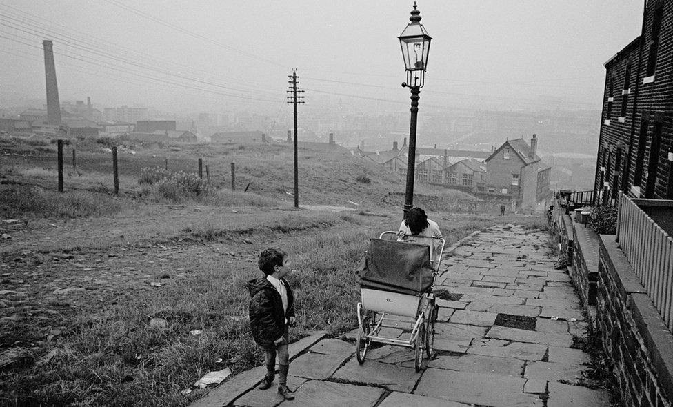 Pushing pram up an unadopted road, Bradford 1970