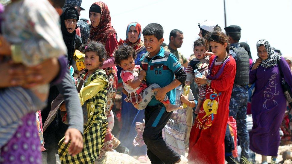 Iraqi families are pictured near al-Sejar village, in Iraq's Anbar province, after fleeing the city of Falluja, on May 27, 2016