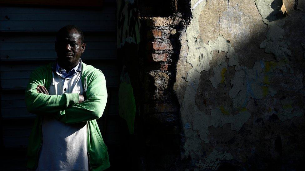 A migrant outside an abandoned building in Rome's Tiburtina district