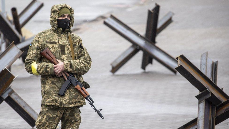 A Ukrainian soldier patrols in front of the Independence Monument during Russian attacks in Kyiv, Ukraine. Photo: 3 March 2022