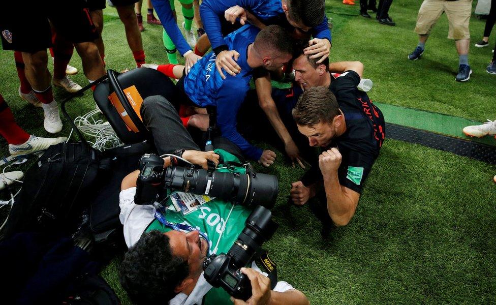 Croatia players celebrate next to an AFP photographer Yuri Cortez