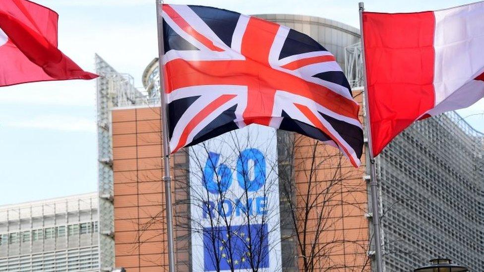 A British flag flies in front of a banner to mark the 60th anniversary of the EU at the European Commission's headquarters in Brussels. Photo: 21 March 2017