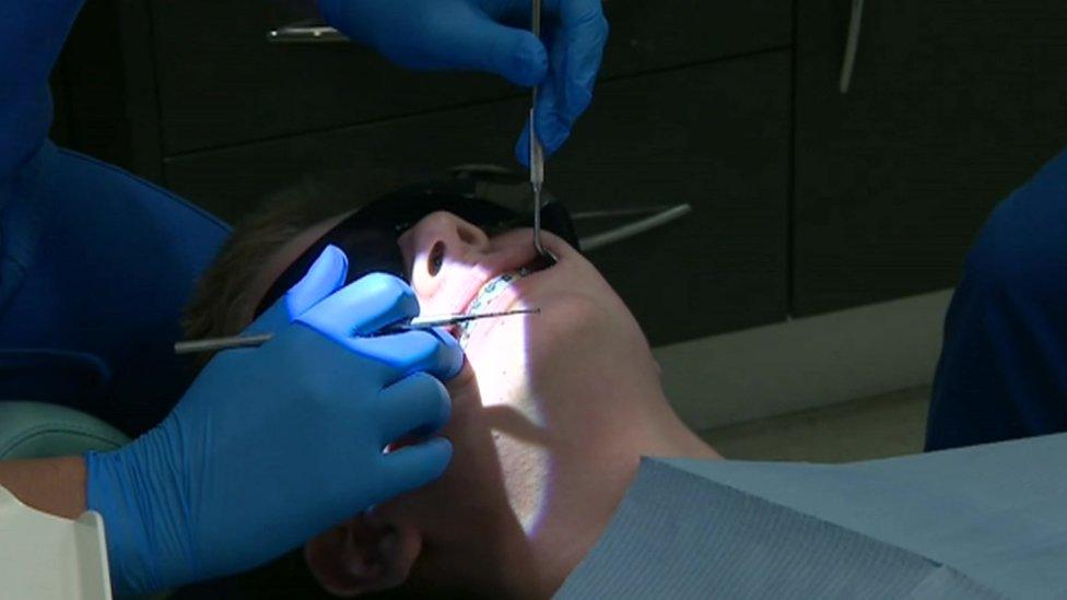 Dentist treating a patient with braces