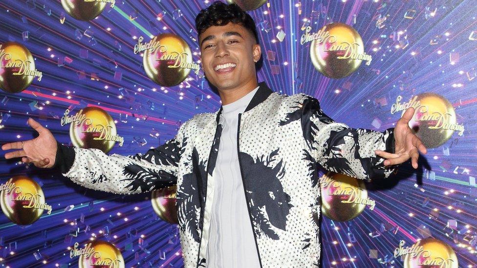 Karim in front of Strictly wallpaper