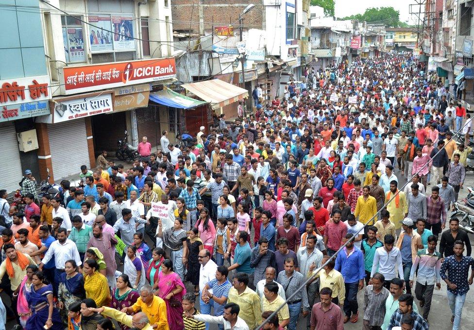 People participate in a rally to protest against the rape of a seven-year-old girl in Mandsaur.