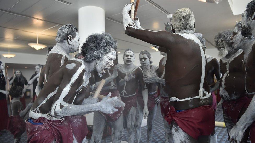 A group of dancers prepare for the performance