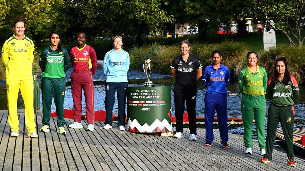 The eight team captains with the Women's World Cup trophy