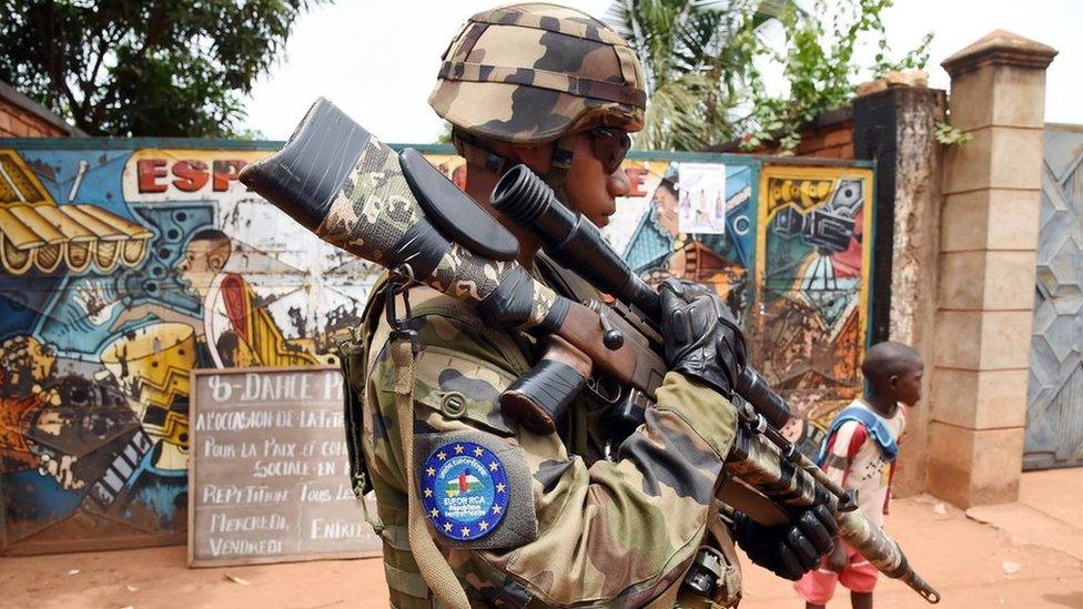 A soldier of the European Union Force (Eufor) in the Central African Republic patrols a street in Bangui (8 May 2014)