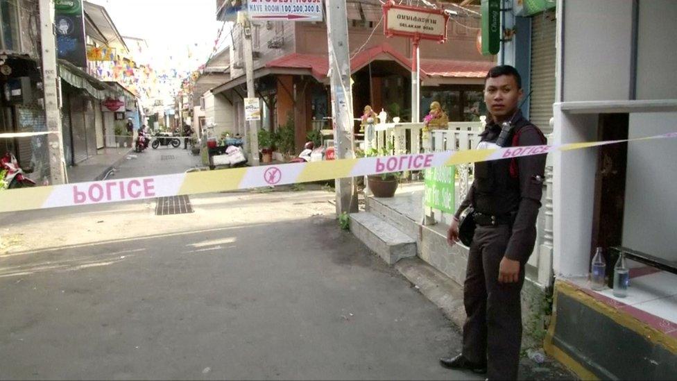 A policeman behind police tape at the site of one of two bomb blasts which occurred on 11 August 2016 in Hua Hin, Thailand. Still image taken from video shot on 12 August 2016.