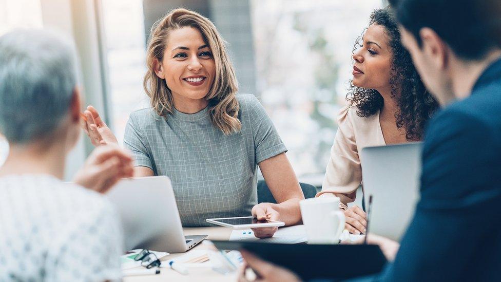 Group of men and women in a business meeting