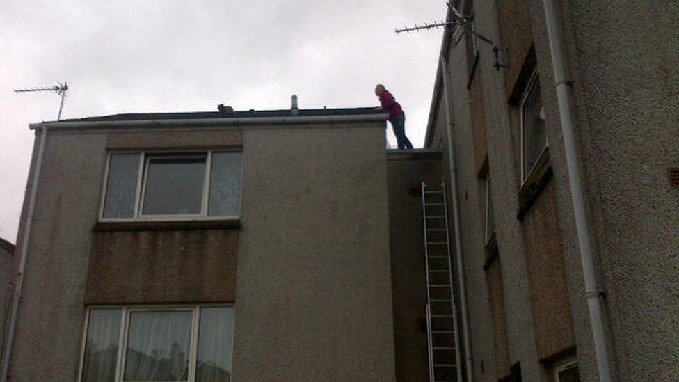 Cat being coaxed off roof in Stornoway