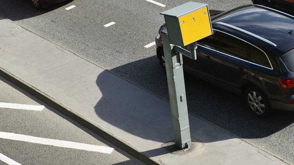 Car driving past speed camera