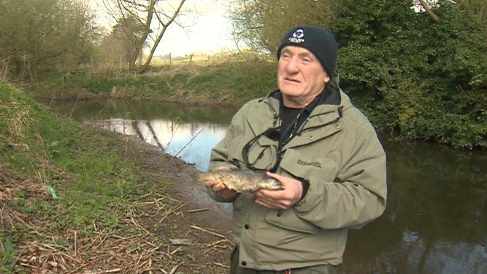 Ron Wood holding a dead fish