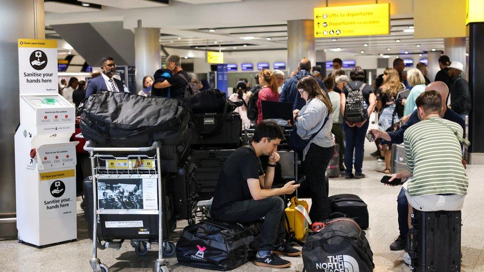 Travellers waiting at Heathrow Airport