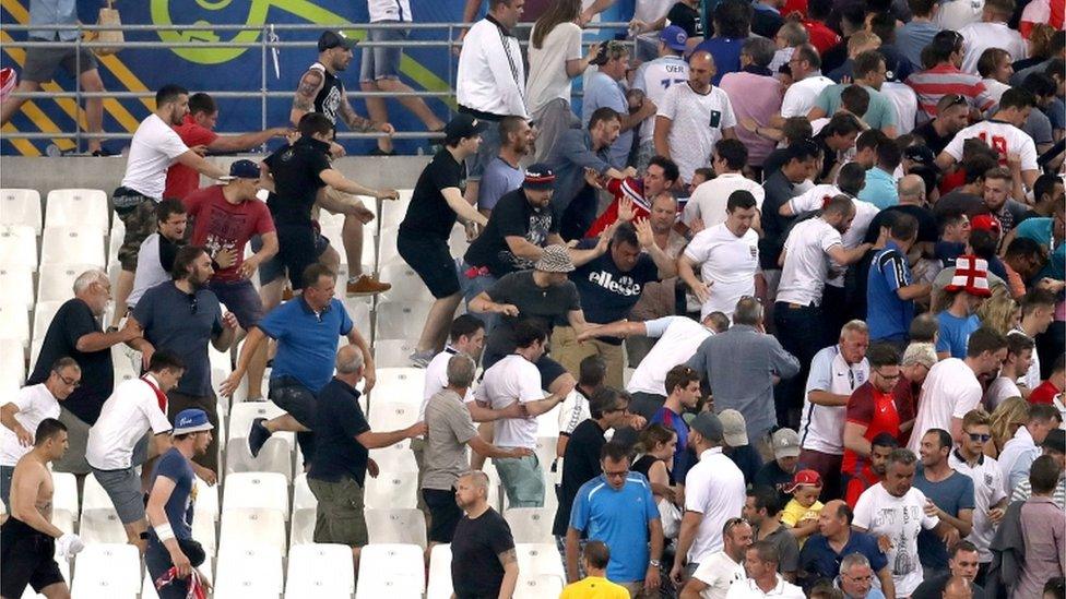 Russia fans, some wearing scarves over their faces, rushed towards England fans at the end of the match