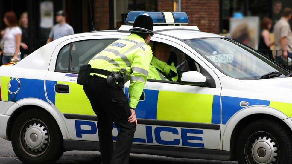 Police officers attend crime scene