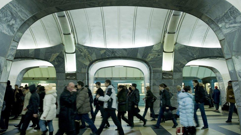 Passengers walking through a Moscow metro station