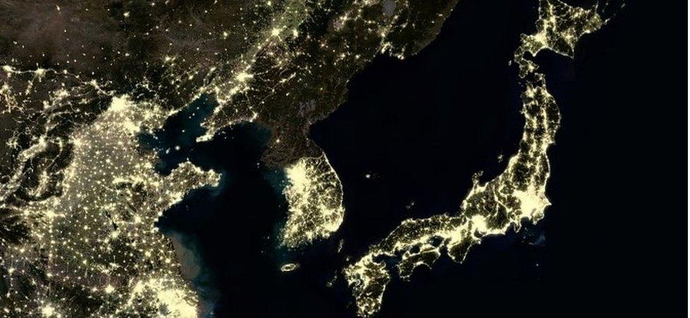 Night time satellite image showing North Korea with few artificial lights