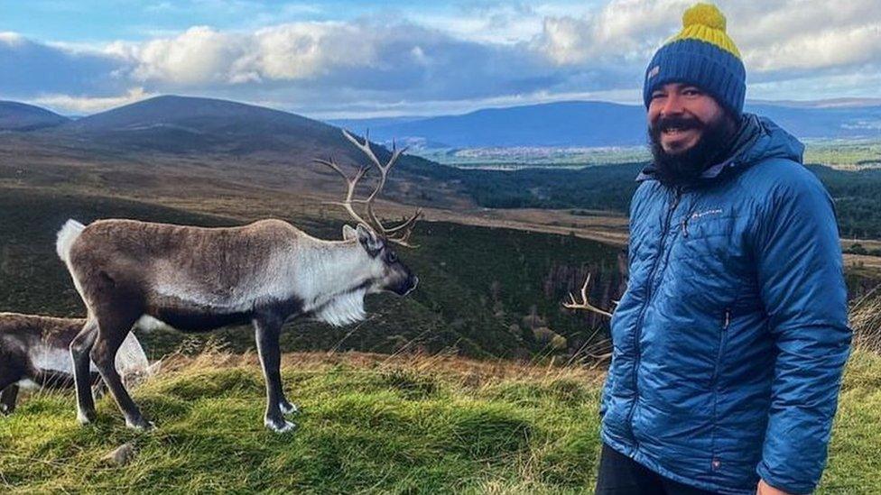 Chris Howard with a deer in the Scottish hills