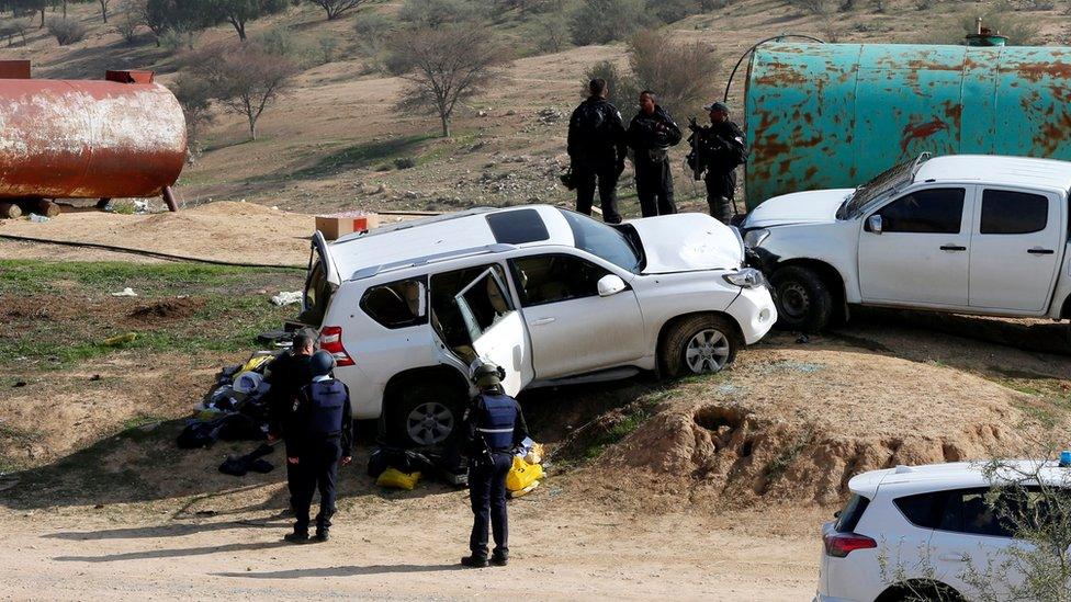 A car (L) that Israeli police said was used by an Arab Israeli to ram into a group of policemen in Umm al-Hiran on 18 January 2017