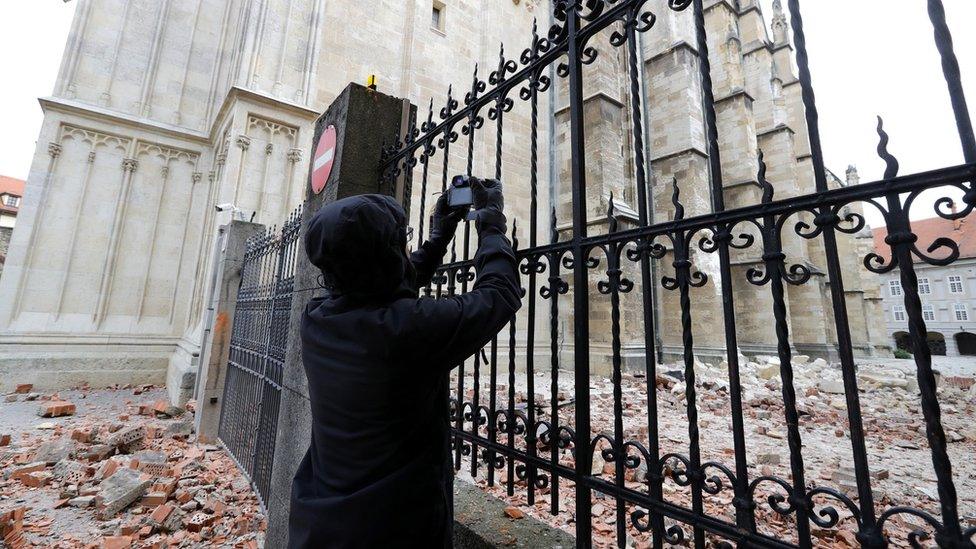 A person takes photos of damage caused by a 5.3-magnitude earthquake that hit near Zagreb, Croatia, 22 March 2020