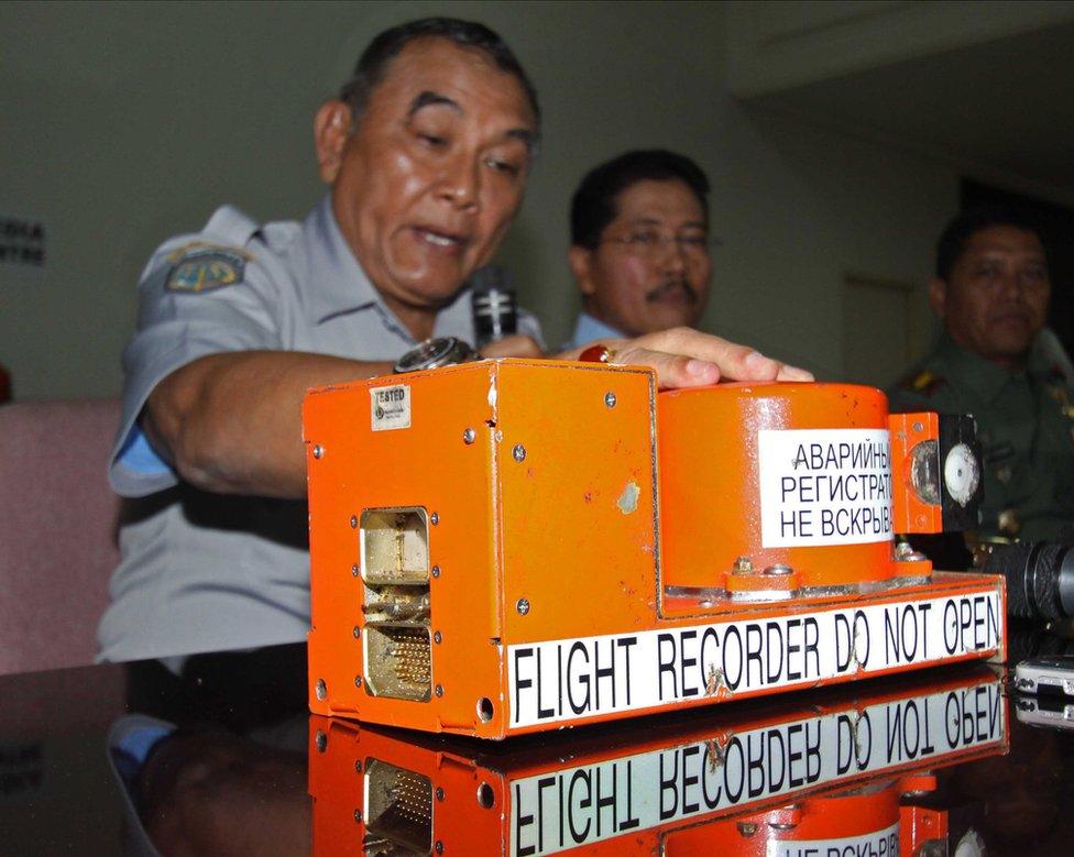 Indonesian officials give a press conference next to the flight data recorder of a crashed passenger jet on May 31, 2012.