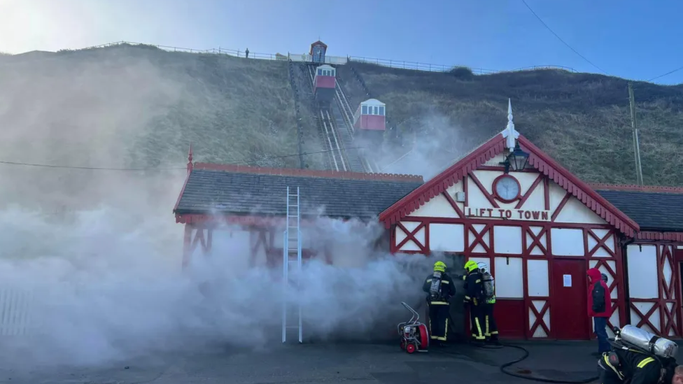 Smoke seen billowing from railway's building on cliffside