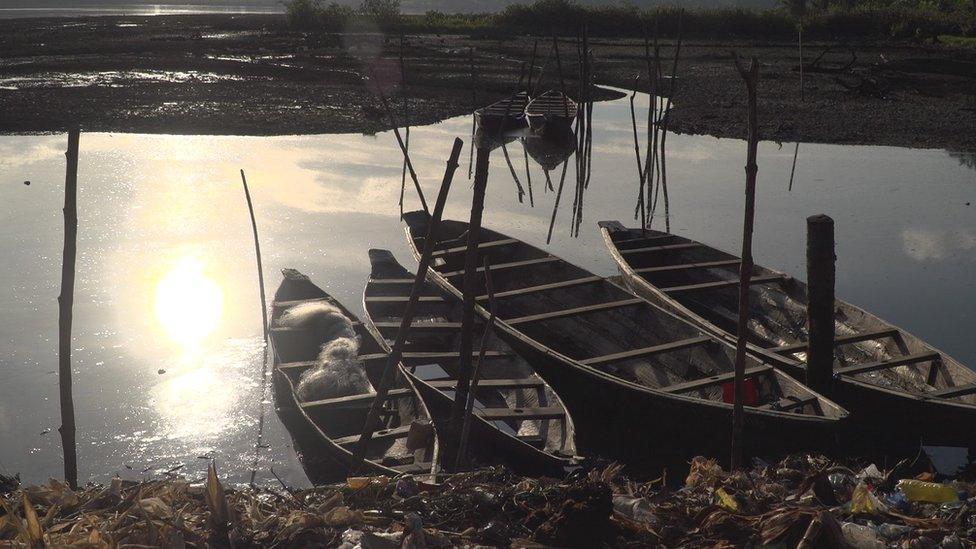 Fishing canoes on polluted creek