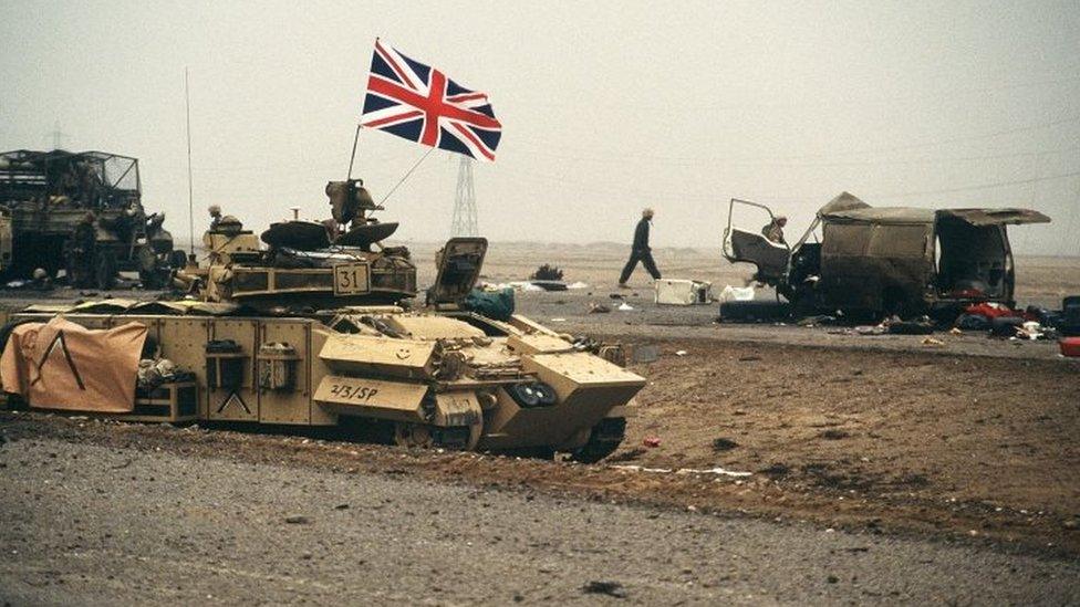 The British flag waves from an armored personnel carrier of the 7th Brigade Royal Scots as it advances along the Basra-Kuwait Highway