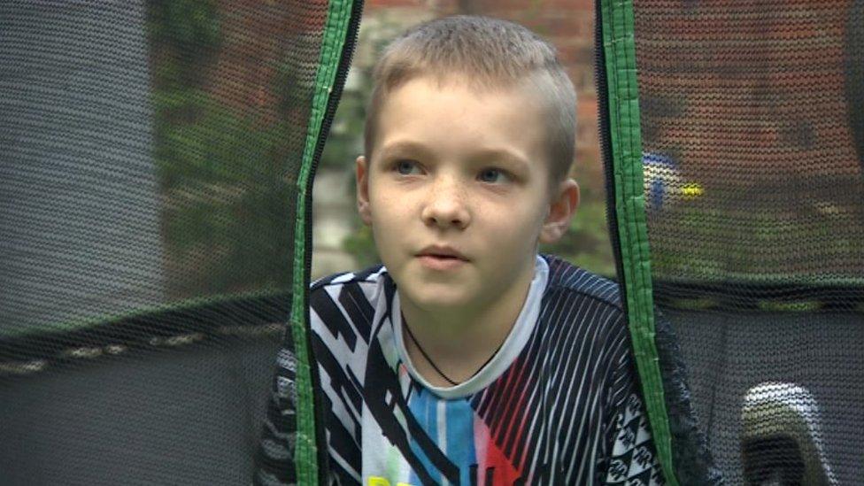 Max Clark lying on his trampoline