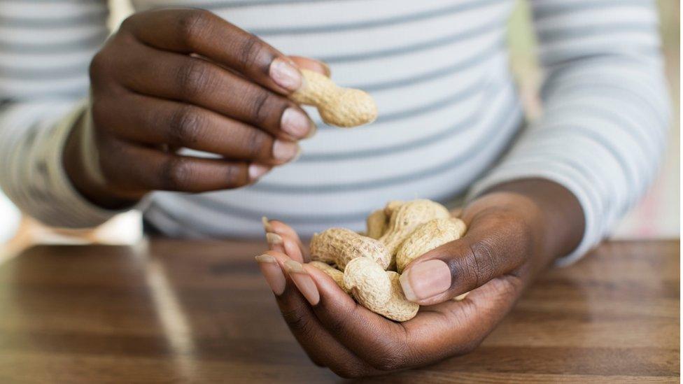 Teenager eating peanuts