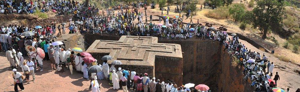 Ethiopian Orthodox Christian gather near to the rock-hewn church Bete Giyorgis during the annual festival of Timkat in Lalibela, Ethiopia which celebrates Epiphany, the Baptism of Jesus in the Jordan River, on 20 January 2012