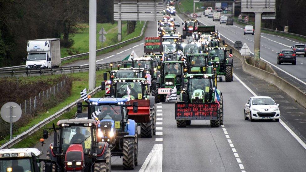 Farmers outside Rennes, France during nationwide protests over pay, tax and regulations