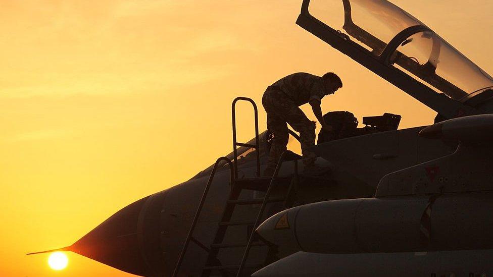 Pilot climbing into a jet