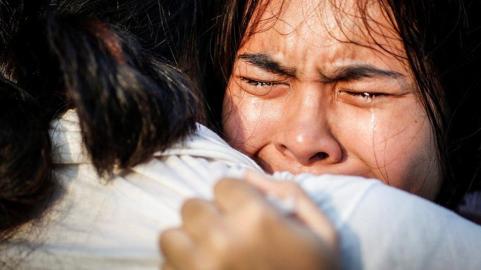 Thai women weep after the death of the king