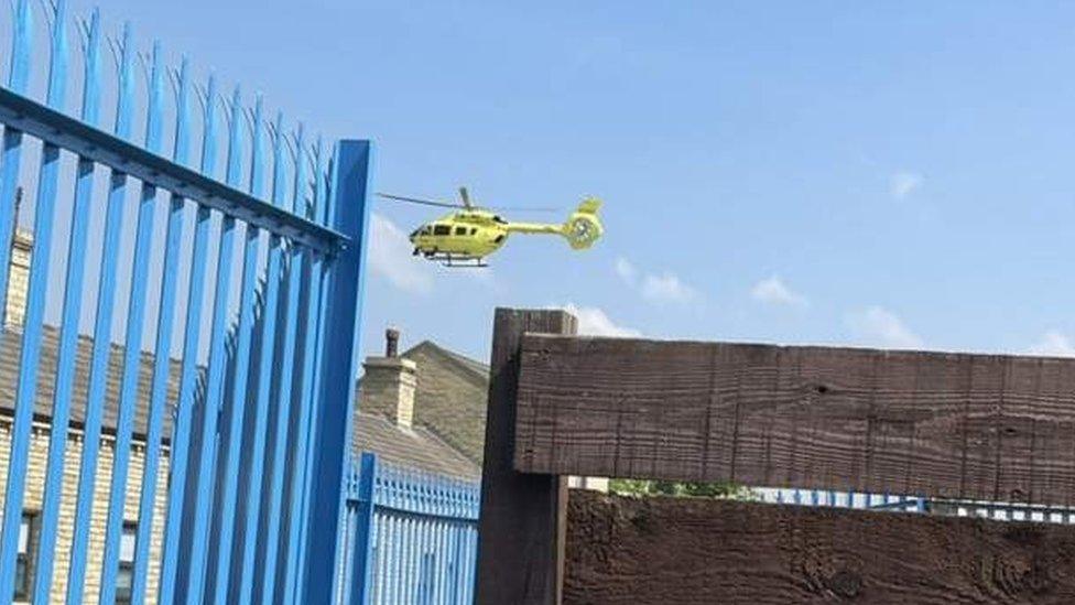 An air ambulance flying at the scene