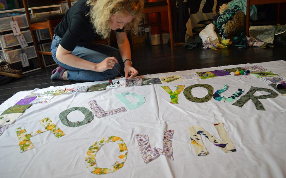 Girl Gang Manchester with their "Hold Your Own" banner