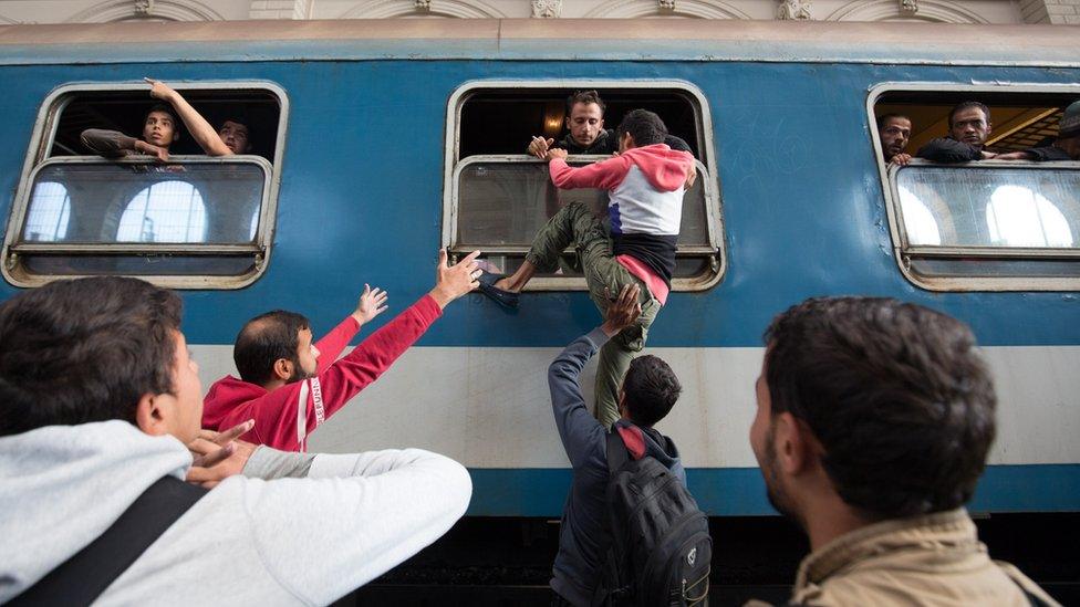 Migrants board a train in Keleti station after it was reopened this morning in central Budapest on September 3, 2015 in Budapest, Hungary