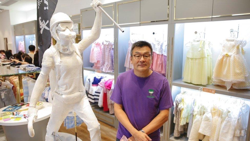 Chickeeduck founder Herbert Chow poses next to the two-meter-tall 'Lady Liberty'