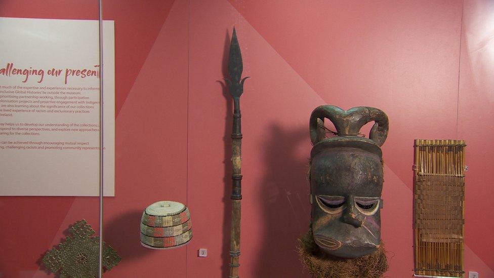 Ulster Museum display of artefacts including spear it says was taken from Benin in 1897