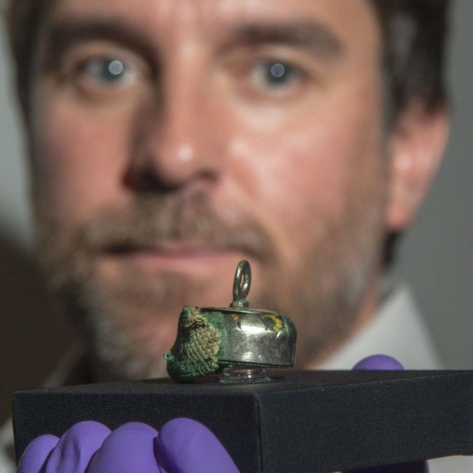 Dr Martin Goldberg and a relic bead pendant with traces of rare textiles from the Galloway Hoard