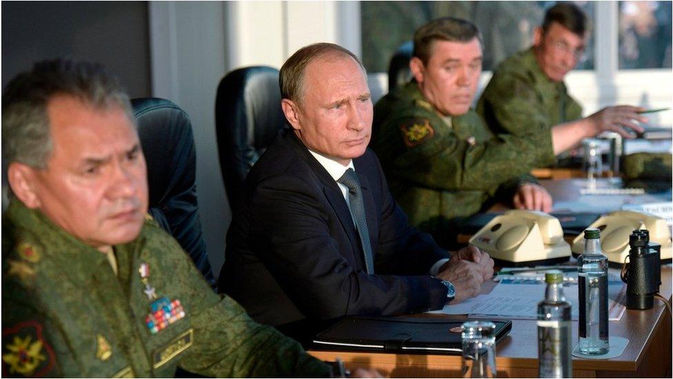 Russian President Vladimir Putin flanked by Defence Minister Sergei Shoigu, left, and Chief of the General Staff of the Russian Armed Forces Valery Gerasimov